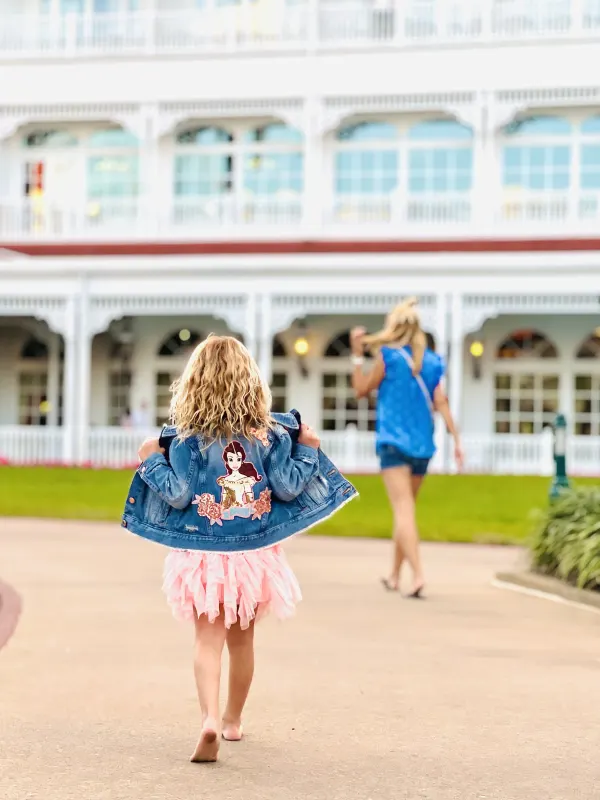 Walking up to the main building's wraparound veranda — the grand Victorian footprint set the template for every later Disney deluxe resort.