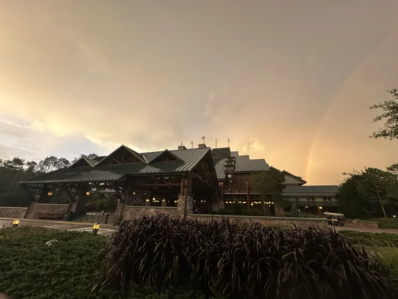 The lodge from the front lawn at sunset — a rainbow over Bay Lake after a summer afternoon storm.