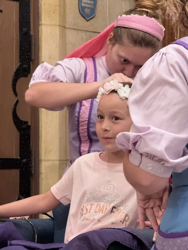 The floral-crown finish — kids pick from princess hairstyles, the makeover includes nails and a sash, and ends with a 'You look beautiful' moment.