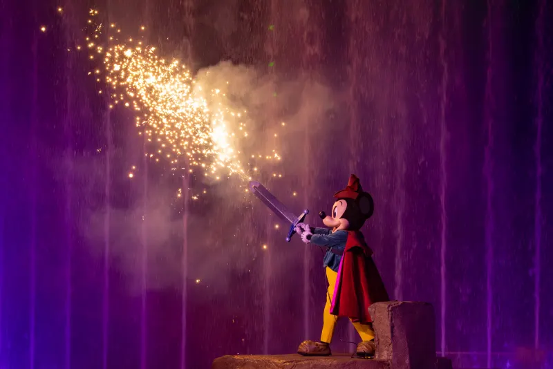 Pyro blast during the finale — close enough that you feel the warmth from the dining-package rows.