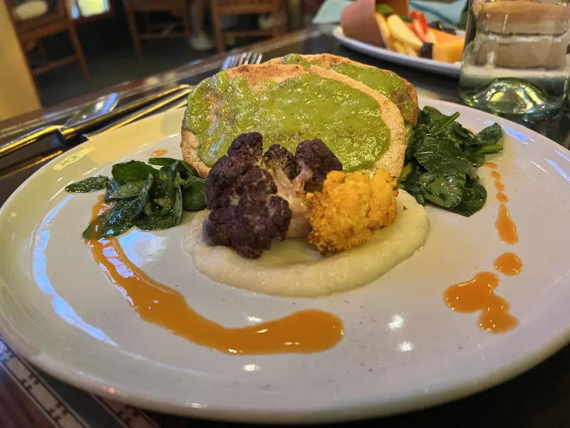 A prix fixe entrée — tenderloin with chimichurri, roasted purple and tempura cauliflower, and a green pea purée. The menu rotates seasonally.