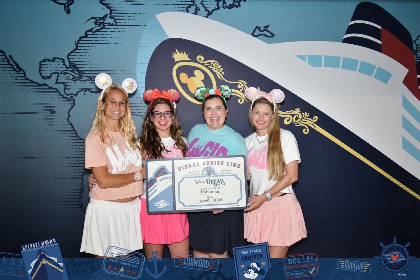 Four Fairytale Dreamers team members in Minnie ears holding a Disney Cruise Line boarding placard for the Disney Dream