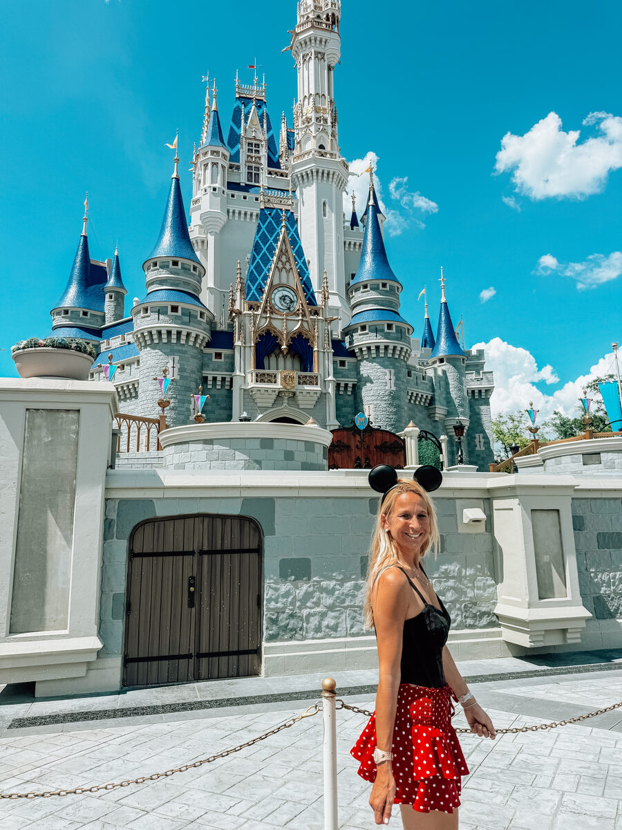 Fallon in Mickey ears in front of Cinderella Castle