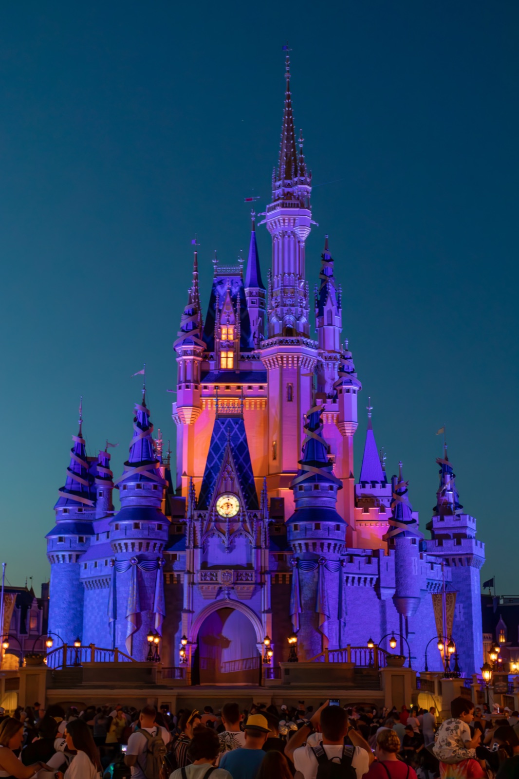 Cinderella Castle backlit in royal purple just after sundown.
